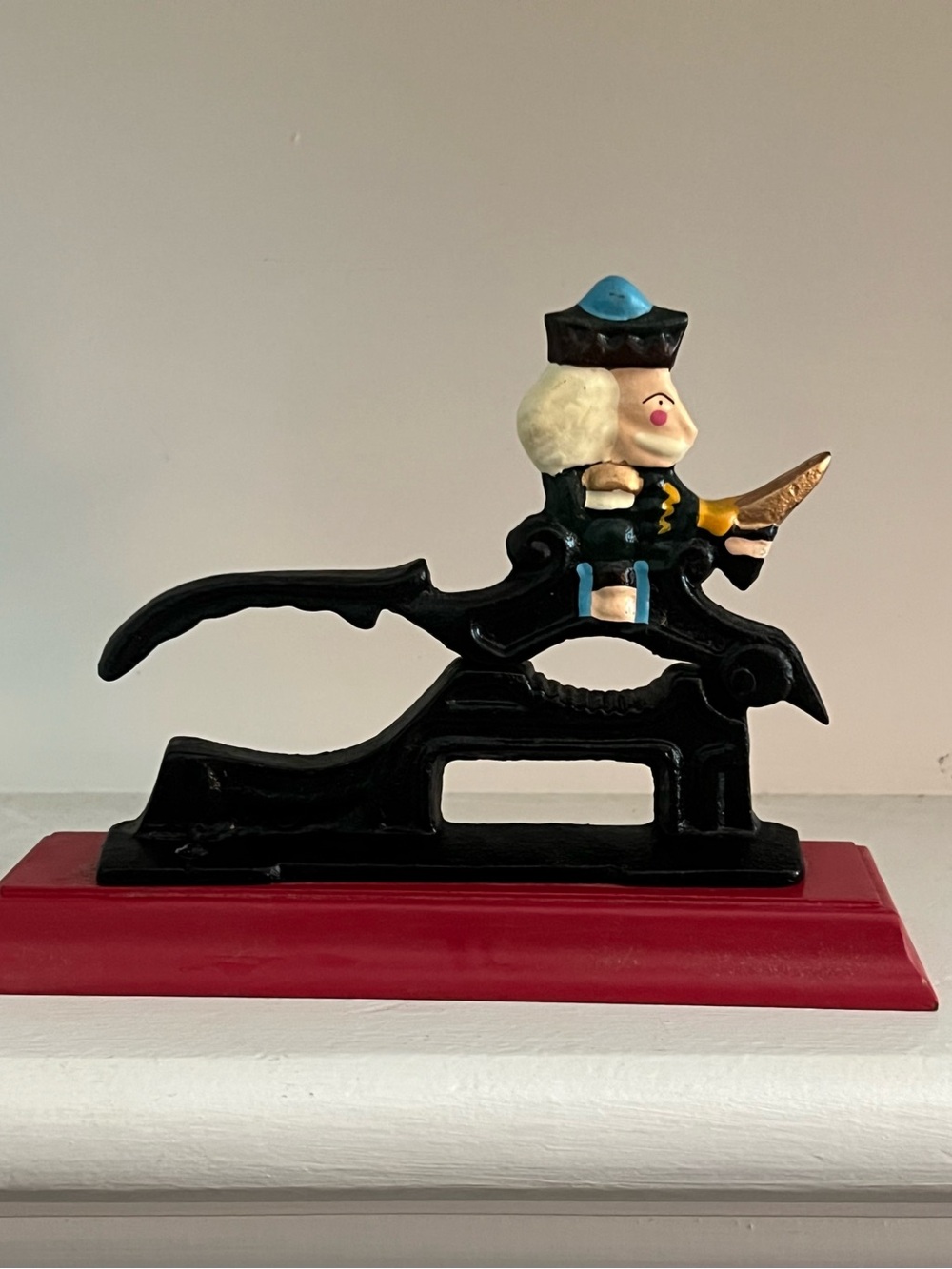 Black Cast Iron Nutcracker Figurine with Blue and Gold Accents